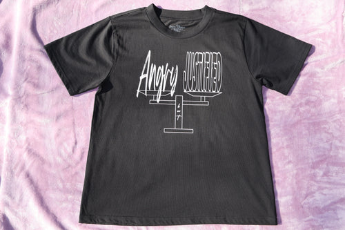 Black t-shirt with white 'Angry but Justified' text and graphic design on a lavender background