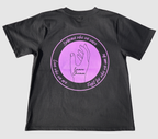 The back of a black t-shirt with a purple graphic design featuring the outline of a hand and text on a gray background.