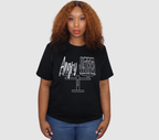 Woman wearing a black t-shirt with white 'Angry but Justified' graphic design, standing against a gray background.