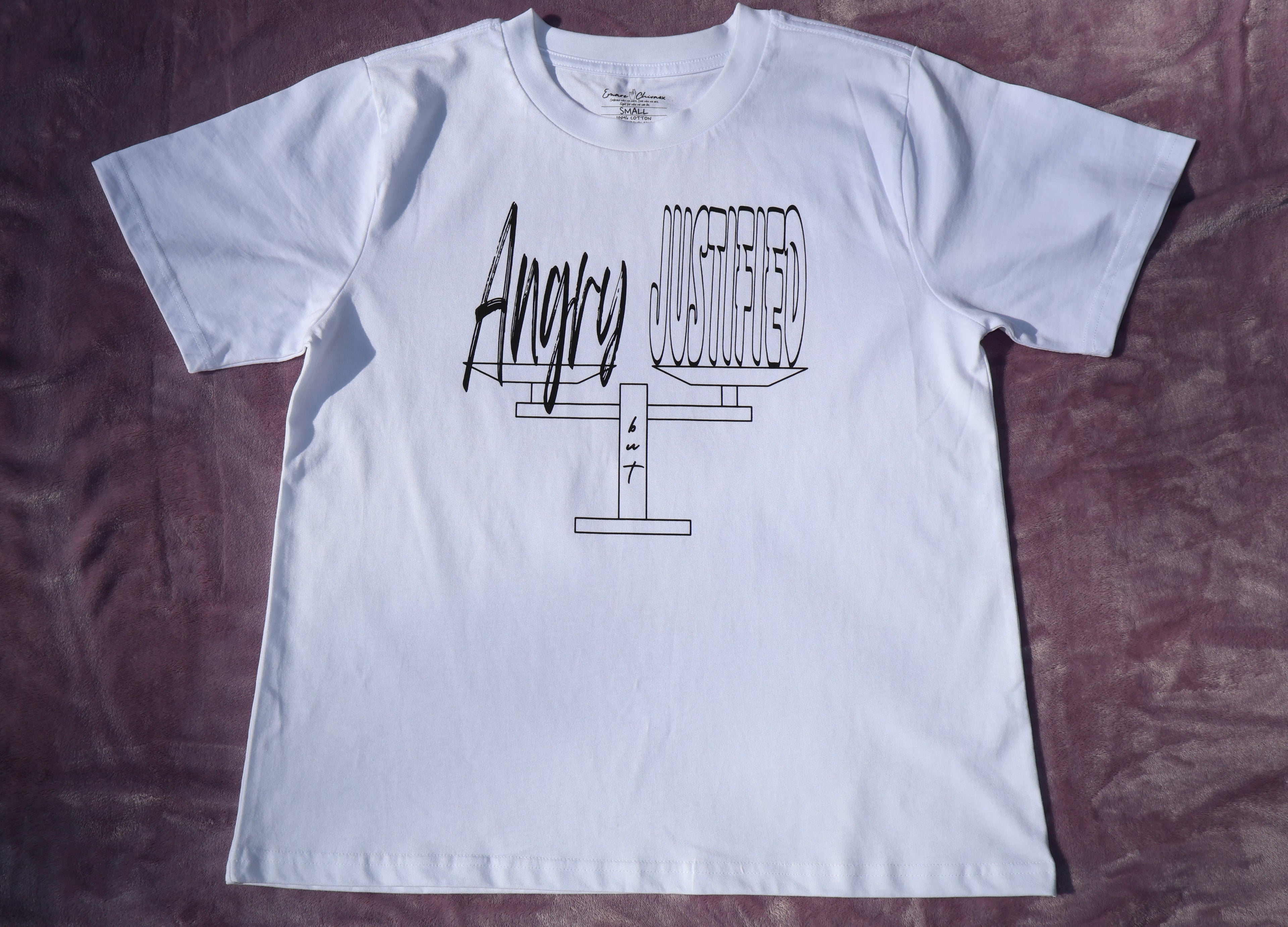 White t-shirt with black 'Angry but Justified' text and graphic design on a lavender background.