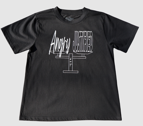 The front of a black t-shirt with white 'Angry but Justified' graphic design on a gray background.