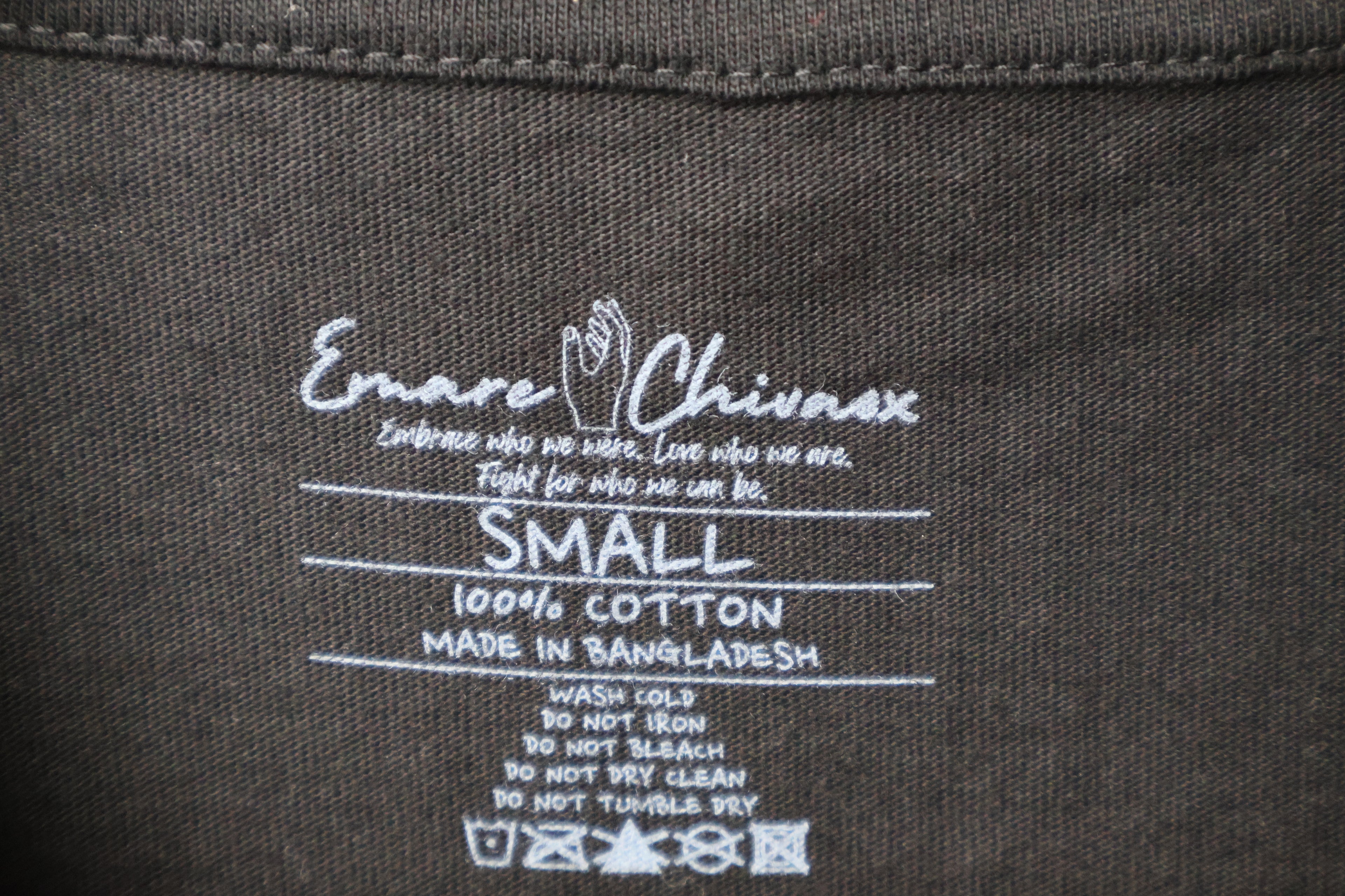 Close up of black t-shirt with custom white Emare Chivaox neck tag.