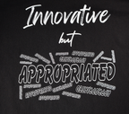 Zoomed in view of black t-shirt with white 'Innovative but Appropriated' graphic design.