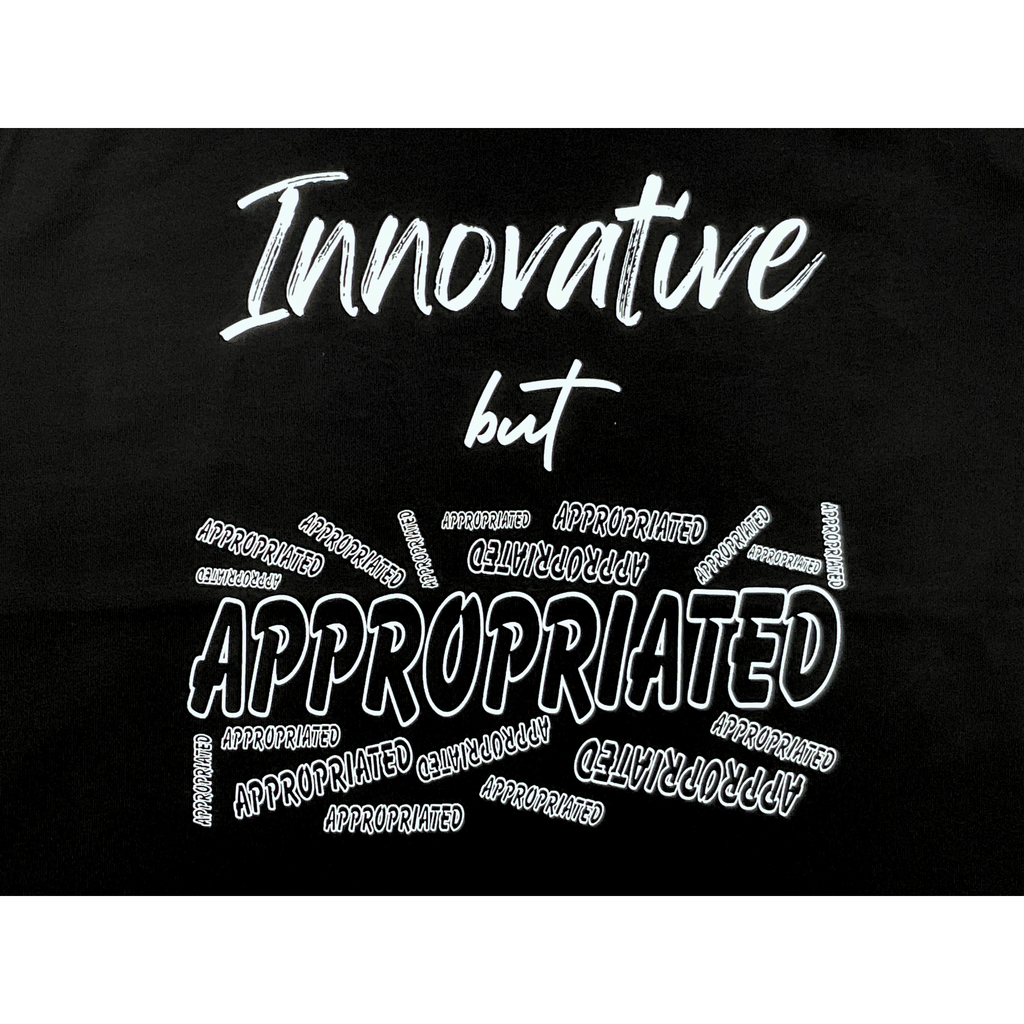 Center of black t-shirt with "Innovative but Appropriated" white text design on a white background