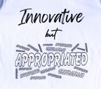 Zoomed in view of white t-shirt with black 'Innovative but Appropriated' graphic design.