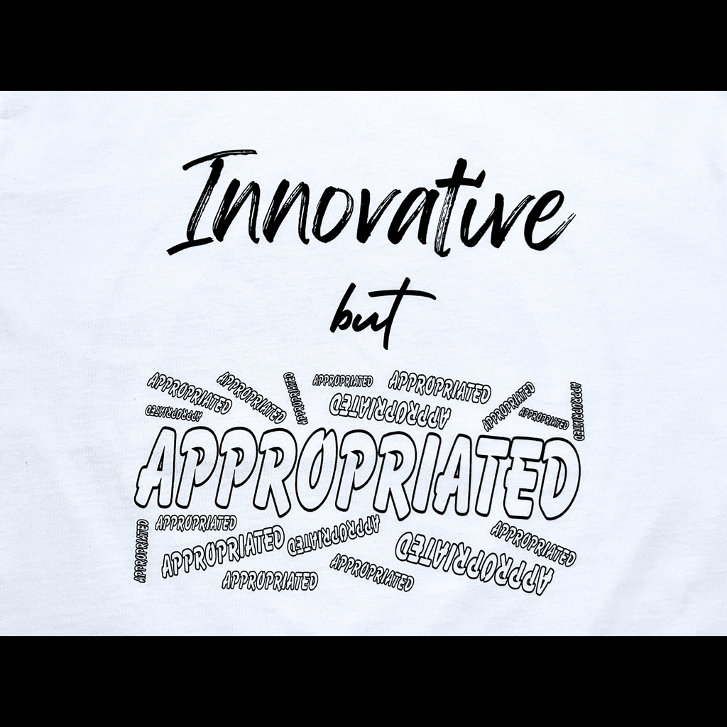 Center of white t-shirt with "Innovative but Appropriated" black text design on a black background