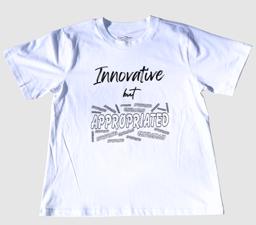 The front of a white t-shirt with black 'Innovative but Appropriated' graphic design on a gray background.