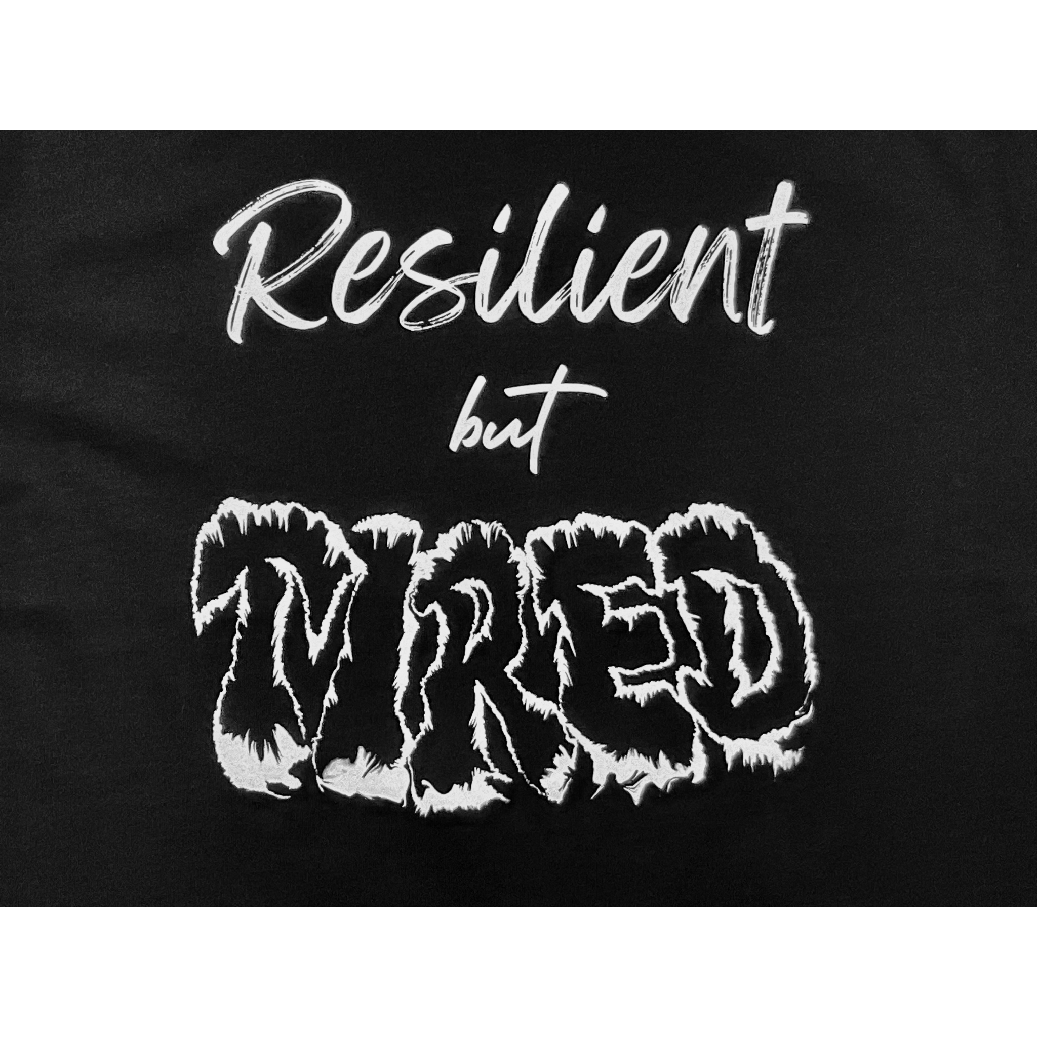 Center of black t-shirt with "Resilient but Tired" white text design on a white background