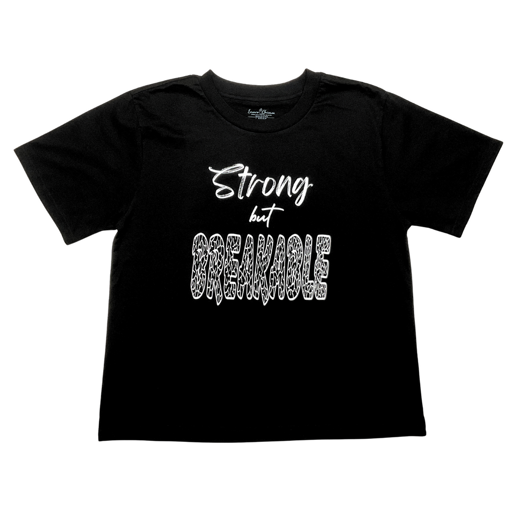 Front of black t-shirt with "Strong but Breakable" white text design on a white background