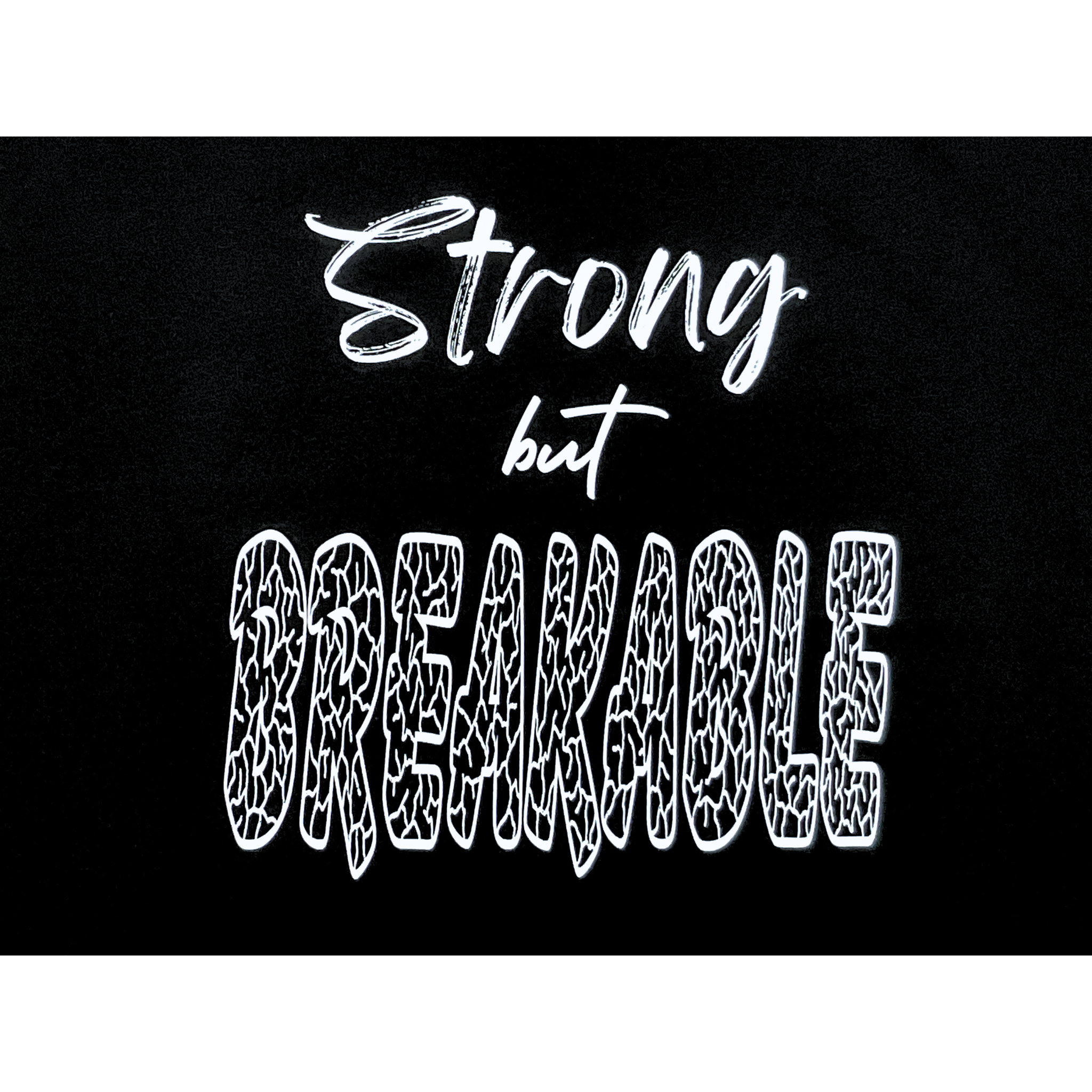 Center of black t-shirt with "Strong but Breakable" white text design on a white background