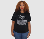Woman wearing a black t-shirt with white 'Strong but Breakable' graphic design, standing against a gray background.