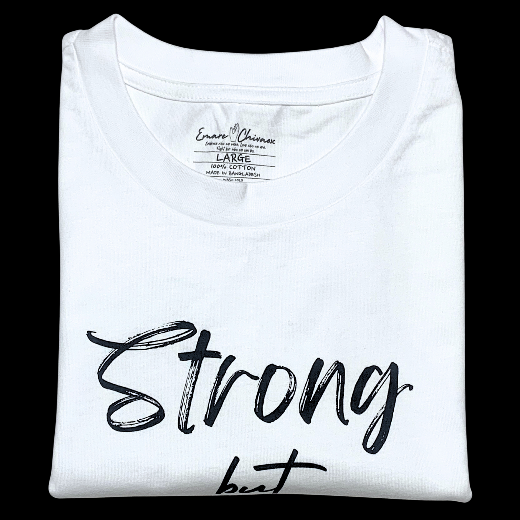 Front of white t-shirt folded with "Strong but" black text design on a black background