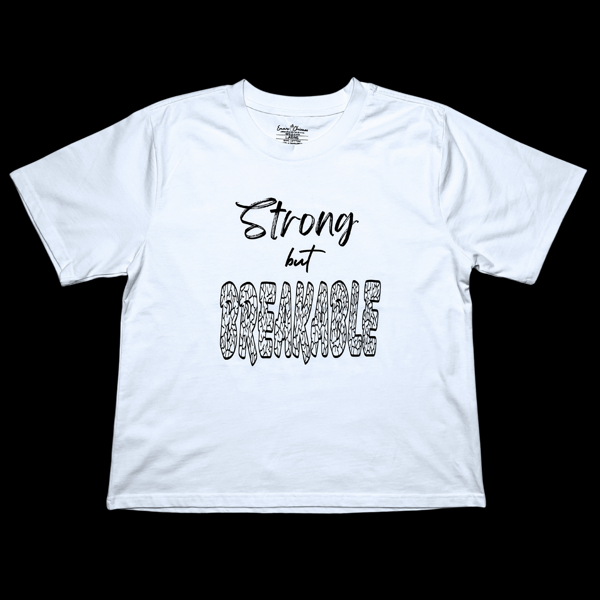 Front of white t-shirt with "Strong but Breakable" black text design on a black background